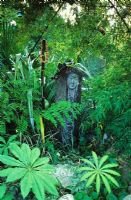 Marsha Donahue's garden in Berkeley,  California USA. Sculptural fantasy garden with Earth mother figure. 
