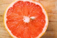 Half a grapefruit on chopping board