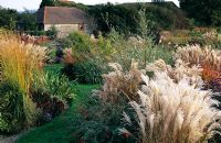Autunm borders with ornamental grasses and perennials at Marchants, Sussex  