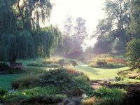 The Dell Garden at Bressingham in Norfolk View of the garden early on a misty morning 