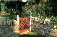 Painted wooden Garden Gate set in dry stone wall