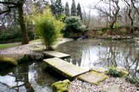 Stone bridge in Japanese Garden at Pine Lodge Gardens Near St. Austell.