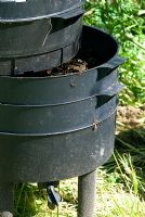 Wormery (Worm Tower or Can-o-worms) used to turn garden and kitchen waste into garden compost by the action of worms. Middle level tray with part worked waste - the majority of the worms are here
