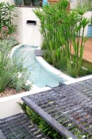 Chic compact small urban garden with water feature
