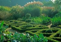 Potager with parterre in vegetable garden edged by grass borders beyond - Glen Chantry, Essex 
