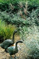 Geese sculptures in gravel garden