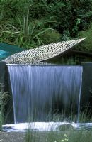 Contemporary waterfall with stainless steel leaf sculpture. '100 Pure New Zealand' Garden, Chelsea Flower Show 2006