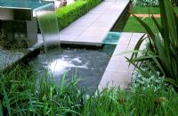 Contemporary glass and steel water feature with pond.  Fleming's Nurseries Australian Garden, Chelsea Flower Show 2006.