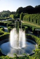 Contemporary metal fountain in circular pond edged with low Buxus hedging - Alnwick Castle, Northumberland