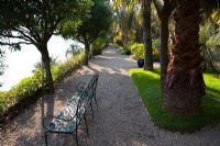 Elegant metal benches overlooking the lake at Isola Madre, Lake Maggiore, Piedmont, Italy 