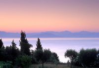 View from garden across sea to mountains beyond with beautiful late evening sky - Corfu

