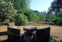Stone curved seats around circular table - Corfu