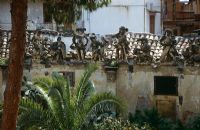 Villa Palagonia, Palermo, Sicily - Grotesque statues made of tufa stone on boudary wall Baroque villa built 1715 with palms and cacti in garden