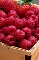 Raspberries and strawberries in a wooden punnet
