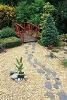 Stepping stones in Gravel leading to bridge in the Japanese garden - White Knights, Buckinghamshire