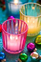 Glass candle holders with Christmas baubles and glitter