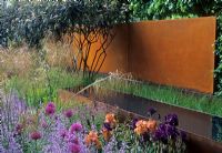 Gold medal and Best in show - Purple planting of Alliums, Nepeta, Irises, Stipa gigantea and Viburnum rhytidophyllum with Corten rusty steel walls - RHS Chelsea 2006 