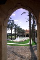 Views through arch of palm trees forming allee and water feature - Lebanon 