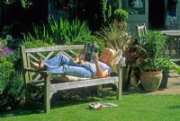 Woman relaxing in her garden - Villa Ramsdal, Essex