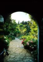 View of mediterranean garden through archway - Cali Doxiadis, Corfu  