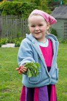 Girl showing the radishes which she grew herself - Pannells Ash Farm, Essex