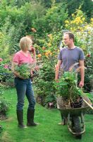 Man and Woman talking in garden whilst gardening