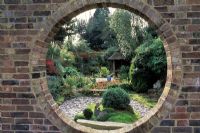 Looking through a moongate to a Japanese style garden