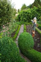 The potager with scarecrow and brick paving - Barnsley House Gardens, Gloucestershire