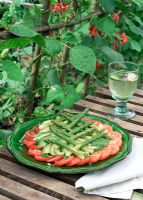 Fresh salad with Tomatoes, Asparagus and Avocado with backdrop of Runner Beans