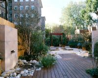 Roof garden with bamboo fence, water feature, white boulders, red cedar deck, bamboo seats and barleycorn gravel