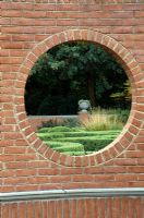 View through a brick wall to an urn - The Blanke Boxwood Garden at the Missouri Botanic Garden, St Louis, USA