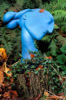 Blue sculpture by Patricia Volk - face in woodland at Greystone cottage, Oxfordshire