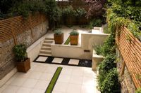 Contemporary garden with planted rill, copper water feature, portuguese limestone paving and steps. Design Charlotte Rowe
