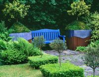 Seating and topiary in Ridler's garden, Swansea, Wales. Design Tony Ridler