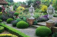 Stone ornaments, parterre, patio, Buxus hedges, topiary, Lavandula and Rosa - Kettle Hill, Norfolk 