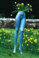 Surrealist inspired image of mannequin legs planted and surrounded by Narrcissi -  Groombridge Place, Kent