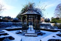 The bandstand in the walled garden covered with snow - Eastleach House Garden, Gloucestershire