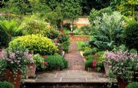 Brick path and steps with pots and fountain