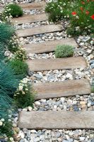 Railway sleeper path set in pebbles - 'Shinglesea' garden, Chelsea 2007 