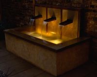 Raised water feature with three copper spouts, cascading water into rectagular pool - Lit with underwater lighting