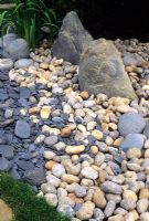 Japanese garden with stones and pebble path