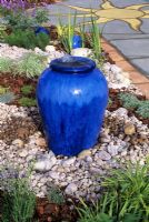 Water feature  with bubbling water in blue glazed container
