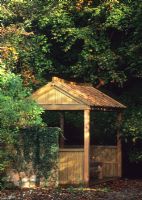 Wooden Summer house in quiet corner of woodland garden