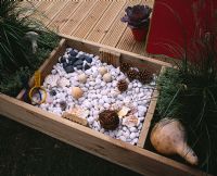 Childrens decking garden, sensory box with pebbles, cones, shells