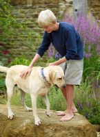 Young boy with dog in garden 