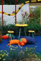 Sunflower chairs and table and blue silicone path in Fisher Price Childrens Garden, Hampton Court FS 