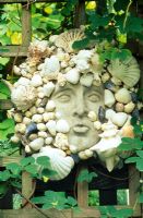 Decorative shell head mounted on trellis 
