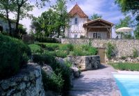 Decked terrace area  beside pool with retaining walls at Chateau Marcoux, Beauville, Provence, France