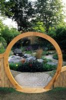 Circular moon gate and cobble path to gravel rock garden area - Feng Shui garden London  