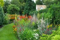 Grass path and herbaceous borders with Lychnis coronaria, Crocosmia 'Lucifer', Salvia sclarea var turkestanica, Heleniums, Erigerons in July